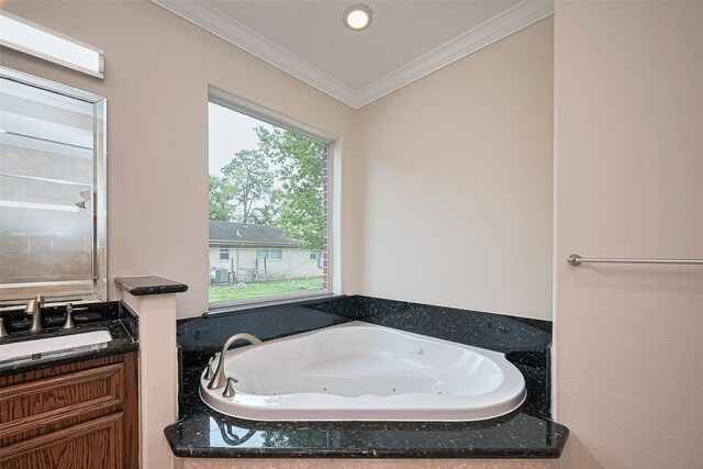 2409 Spears Dr, Humble, TX 77396 - bathroom with ornamental molding, a whirlpool tub, and vanity