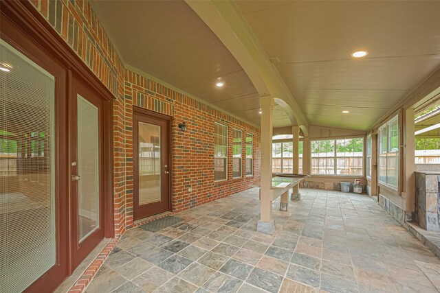 2409 Spears Dr, Humble, TX 77396 - unfurnished sunroom featuring stone tile floors, lofted ceiling, and recessed lighting