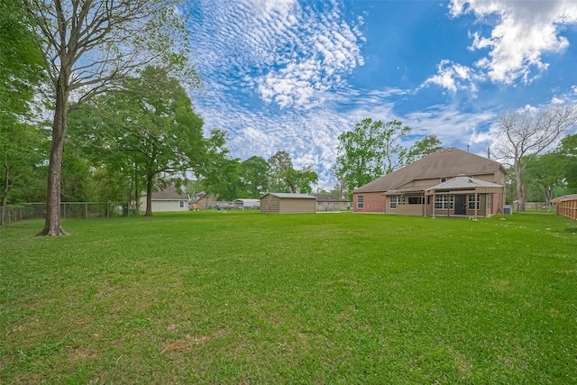 2409 Spears Dr, Humble, TX 77396 - view of yard with a storage unit and an outbuilding