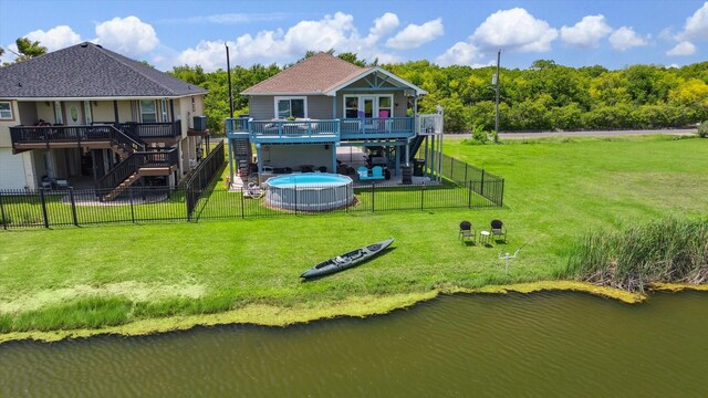 1623 25th St, Dickinson, TX 77539 - back of property with stairway, a deck with water view, and roof with shingles