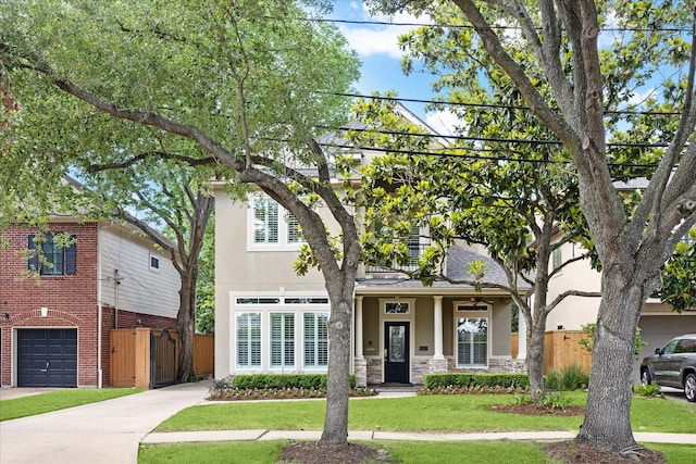 4012 Ruskin St, Houston, TX 77005 - view of front of home with stucco siding, concrete driveway, stone siding, and an attached garage