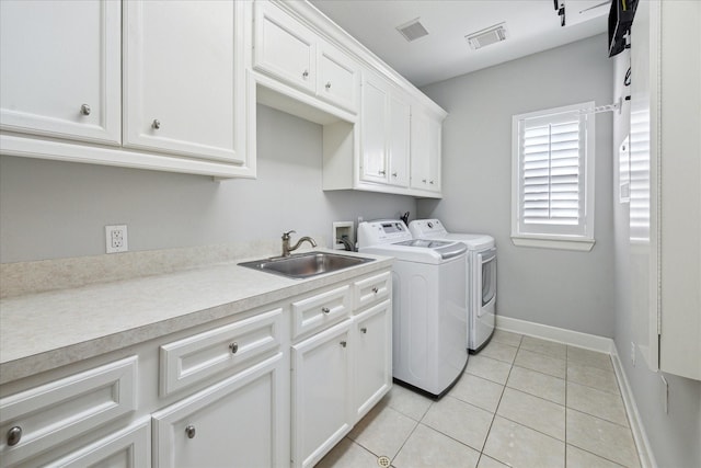 4012 Ruskin St, Houston, TX 77005 - laundry area with cabinet space, washing machine and dryer, baseboards, and light tile patterned flooring
