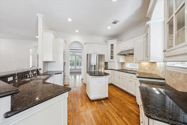 4012 Ruskin St, Houston, TX 77005 - kitchen with a sink, appliances with stainless steel finishes, arched walkways, under cabinet range hood, and light wood finished floors