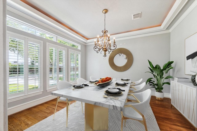 4012 Ruskin St, Houston, TX 77005 - dining space featuring healthy amount of natural light, a raised ceiling, wood finished floors, and ornamental molding