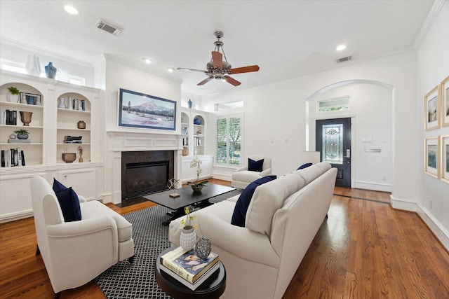 4012 Ruskin St, Houston, TX 77005 - living room with a fireplace with flush hearth, wood finished floors, recessed lighting, ceiling fan, and arched walkways