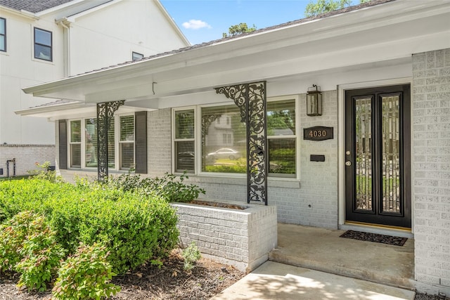 4030 Grennoch Ln, Houston, TX 77025 - doorway to property featuring covered porch and brick siding