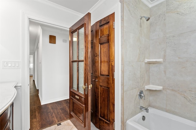 4030 Grennoch Ln, Houston, TX 77025 - bathroom with  shower combination, crown molding, vanity, wood finished floors, and baseboards