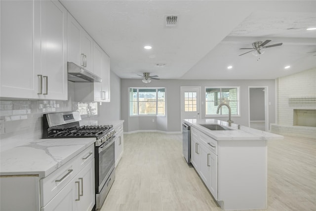 4614 Wee Lassie Ln, Houston, TX 77084 - kitchen featuring appliances with stainless steel finishes, under cabinet range hood, a ceiling fan, a sink, and recessed lighting