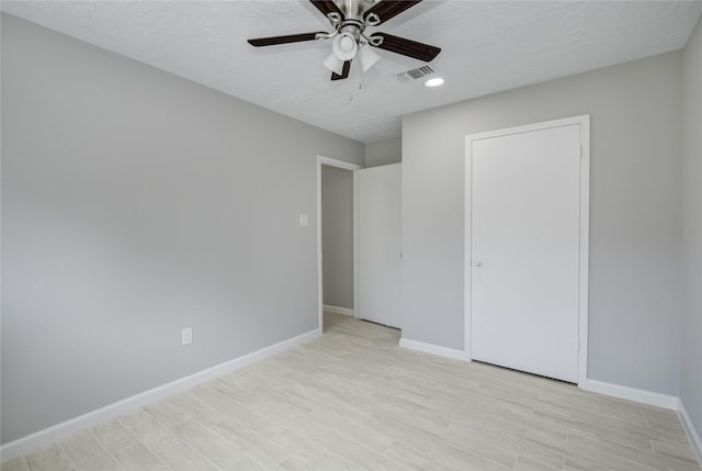 4614 Wee Lassie Ln, Houston, TX 77084 - unfurnished bedroom with baseboards, light wood-type flooring, recessed lighting, ceiling fan, and a textured ceiling