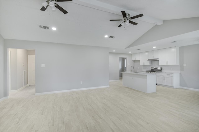 4614 Wee Lassie Ln, Houston, TX 77084 - unfurnished living room featuring ceiling fan, beam ceiling, a sink, baseboards, and light wood-style floors