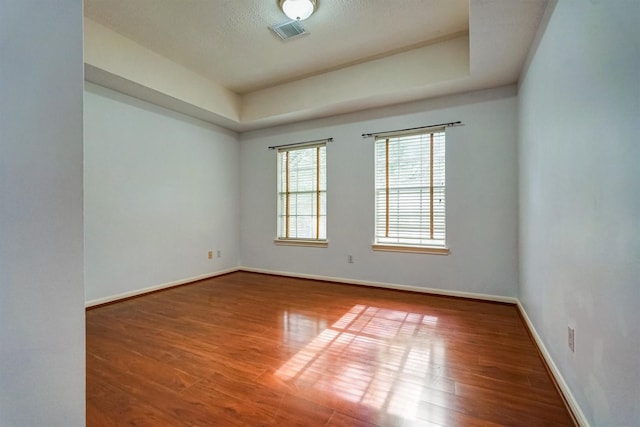 4415 April Meadow Way, Sugar Land, TX 77479 - spare room featuring a raised ceiling, baseboards, and wood finished floors