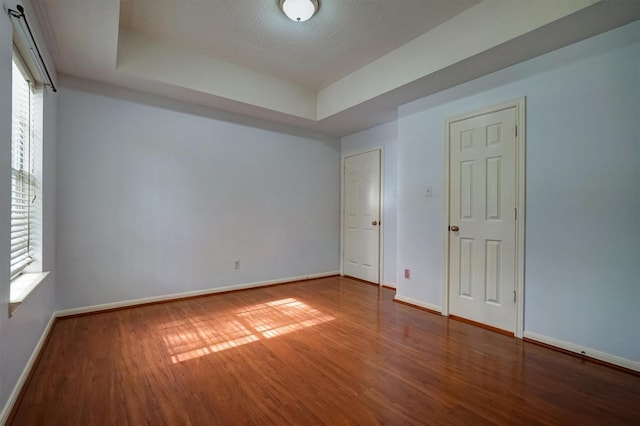 4415 April Meadow Way, Sugar Land, TX 77479 - unfurnished room with a tray ceiling, wood finished floors, and baseboards