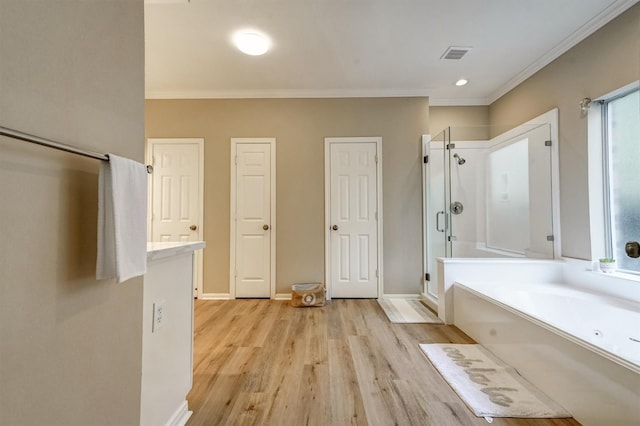 4415 April Meadow Way, Sugar Land, TX 77479 - bathroom featuring wood finished floors, a bath, a stall shower, ornamental molding, and plenty of natural light