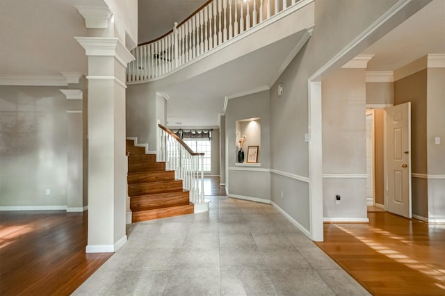 4415 April Meadow Way, Sugar Land, TX 77479 - entryway featuring ornate columns, a towering ceiling, stairs, crown molding, and baseboards