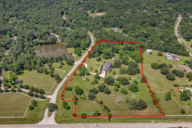 15203 Wildwood Cir, Magnolia, TX 77354 - view of property location with property boundaries highlighted, a heavily wooded area, and a large body of water