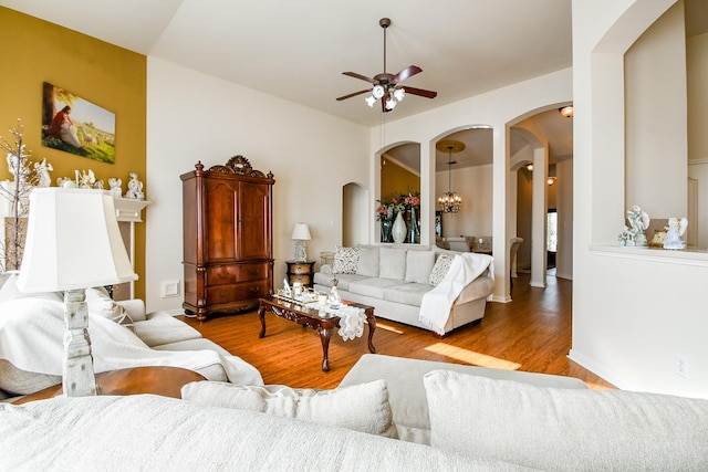 16211 Fleethaven Ln, Houston, TX 77084 - living area with arched walkways, ceiling fan, and wood finished floors