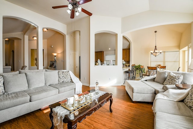 16211 Fleethaven Ln, Houston, TX 77084 - living room with ceiling fan, arched walkways, wood finished floors, lofted ceiling, and a chandelier