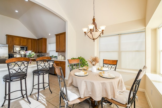 16211 Fleethaven Ln, Houston, TX 77084 - dining room featuring a chandelier, light tile patterned floors, vaulted ceiling, recessed lighting, and arched walkways