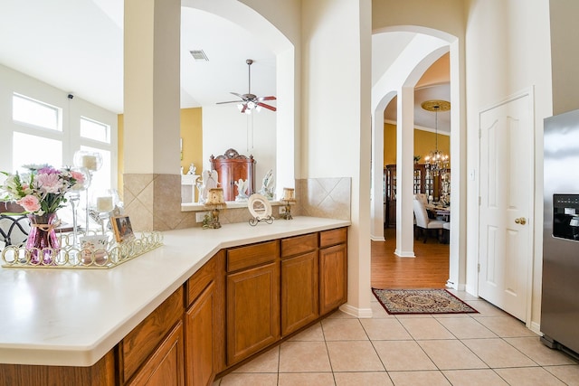 16211 Fleethaven Ln, Houston, TX 77084 - bathroom featuring a ceiling fan, a chandelier, connected bathroom, tile patterned floors, and backsplash