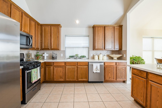 16211 Fleethaven Ln, Houston, TX 77084 - kitchen with stainless steel appliances, brown cabinets, backsplash, and recessed lighting
