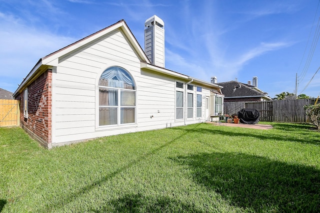 16211 Fleethaven Ln, Houston, TX 77084 - rear view of property with a chimney and a patio