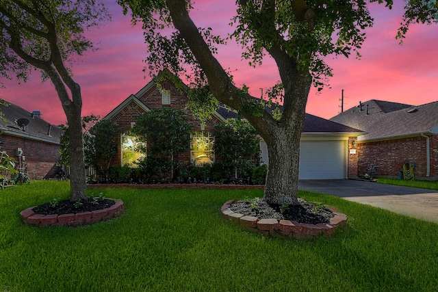 16211 Fleethaven Ln, Houston, TX 77084 - view of front of home featuring brick siding, driveway, a lawn, and a garage