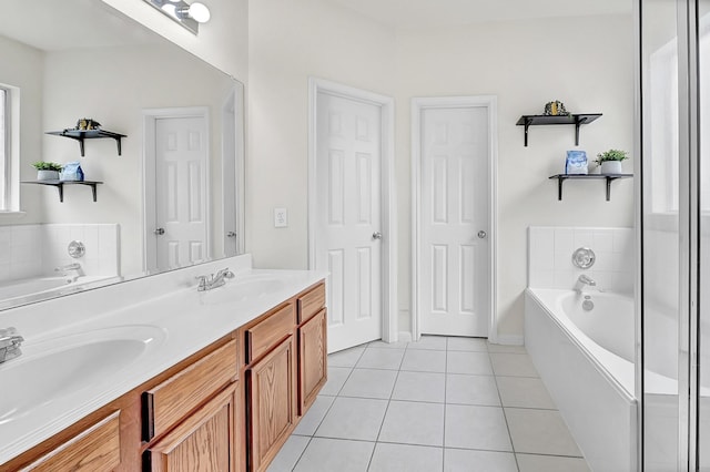 bathroom with tile patterned floors, a bath, and double vanity