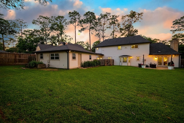 6111 Knollview Dr, Spring, TX 77389 - back of property at dusk featuring a chimney, a patio area, french doors, and central air condition unit
