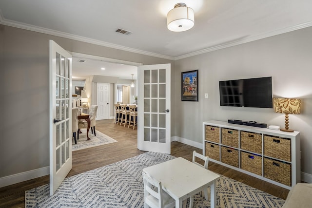 6111 Knollview Dr, Spring, TX 77389 - living area featuring french doors, wood finished floors, baseboards, and crown molding