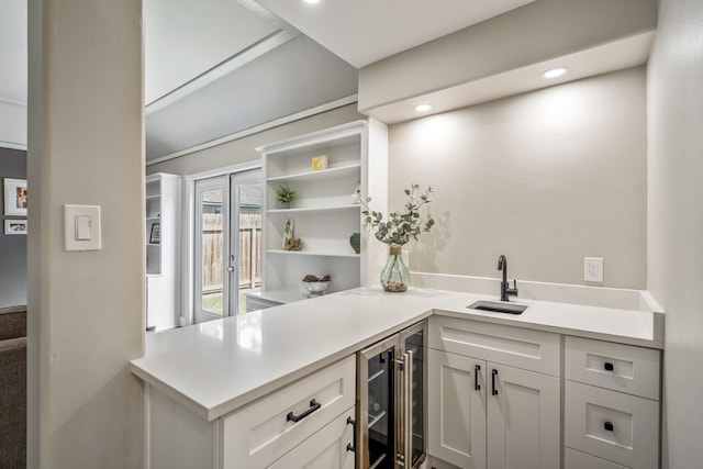 6111 Knollview Dr, Spring, TX 77389 - kitchen with a sink, wine cooler, light countertops, open shelves, and white cabinetry