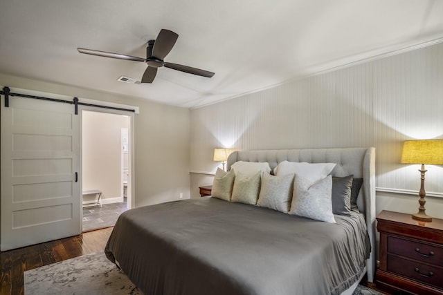 6111 Knollview Dr, Spring, TX 77389 - bedroom featuring a barn door, wood finished floors, crown molding, a ceiling fan, and ensuite bath