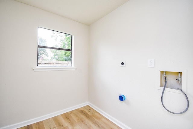 7227 La Granada Dr, Houston, TX 77083 - laundry area with hookup for an electric dryer, baseboards, light wood-style floors, and washer hookup