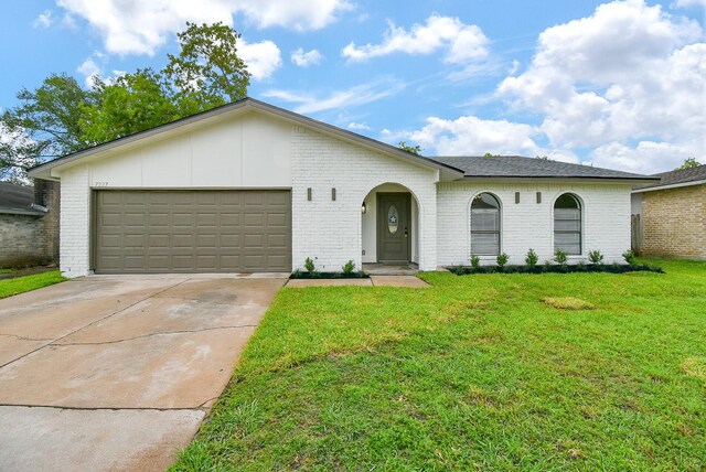 7227 La Granada Dr, Houston, TX 77083 - view of front of home featuring brick siding, a front lawn, concrete driveway, and an attached garage