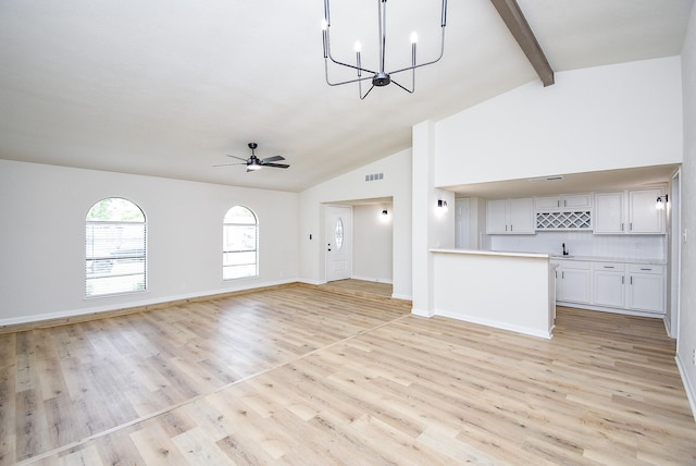 7227 La Granada Dr, Houston, TX 77083 - unfurnished living room with wet bar, light wood finished floors, beam ceiling, a chandelier, and ceiling fan
