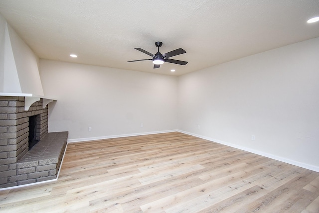 7227 La Granada Dr, Houston, TX 77083 - unfurnished living room with a ceiling fan, light wood-type flooring, a fireplace, recessed lighting, and baseboards