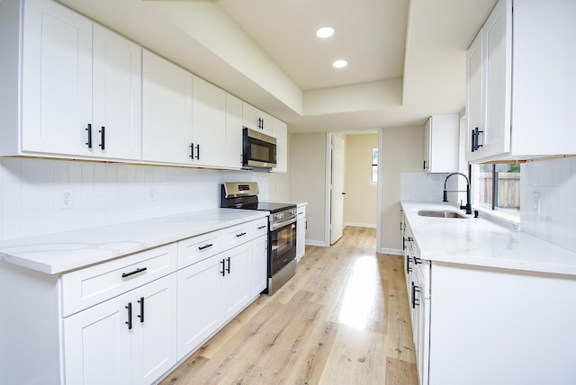 7227 La Granada Dr, Houston, TX 77083 - kitchen with stainless steel appliances, a sink, light wood-type flooring, recessed lighting, and light stone countertops