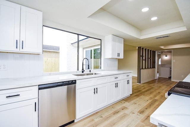 7227 La Granada Dr, Houston, TX 77083 - kitchen with stainless steel dishwasher, a sink, light wood-style flooring, decorative backsplash, and white cabinets