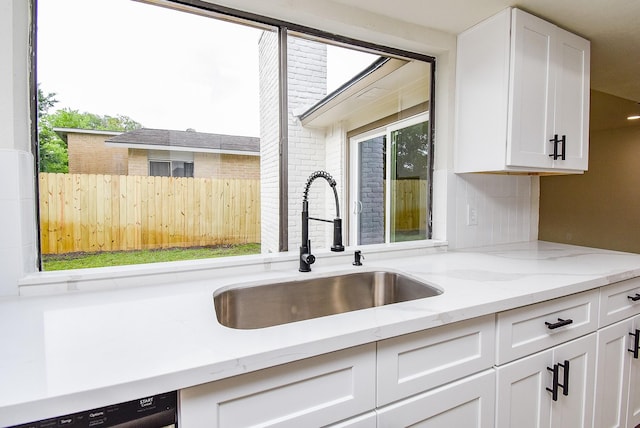 7227 La Granada Dr, Houston, TX 77083 - kitchen featuring a sink, white cabinets, light stone counters, decorative backsplash, and dishwasher