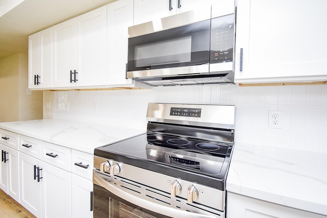 7227 La Granada Dr, Houston, TX 77083 - kitchen featuring stainless steel appliances, white cabinetry, and decorative backsplash