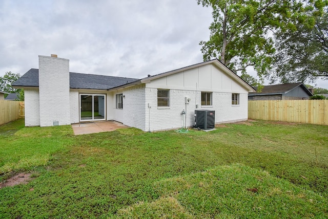 7227 La Granada Dr, Houston, TX 77083 - back of property featuring central air condition unit, a chimney, brick siding, a patio, and board and batten siding