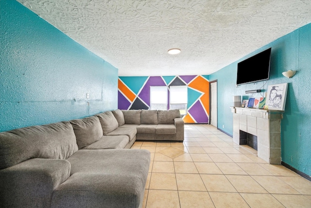 6702 England St, Houston, TX 77021 - living area with a textured wall, an accent wall, a tiled fireplace, a textured ceiling, and light tile patterned floors