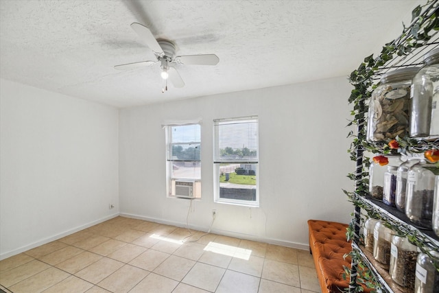 6702 England St, Houston, TX 77021 - unfurnished room with light tile patterned flooring, a ceiling fan, a textured ceiling, and baseboards