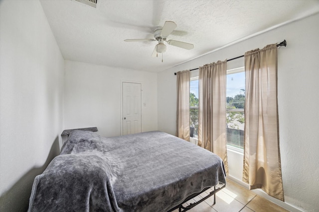 6702 England St, Houston, TX 77021 - bedroom with a textured ceiling, light tile patterned floors, and ceiling fan
