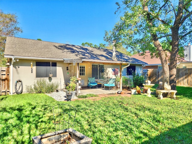 rear view of property featuring an outdoor fire pit, a patio area, and stucco siding