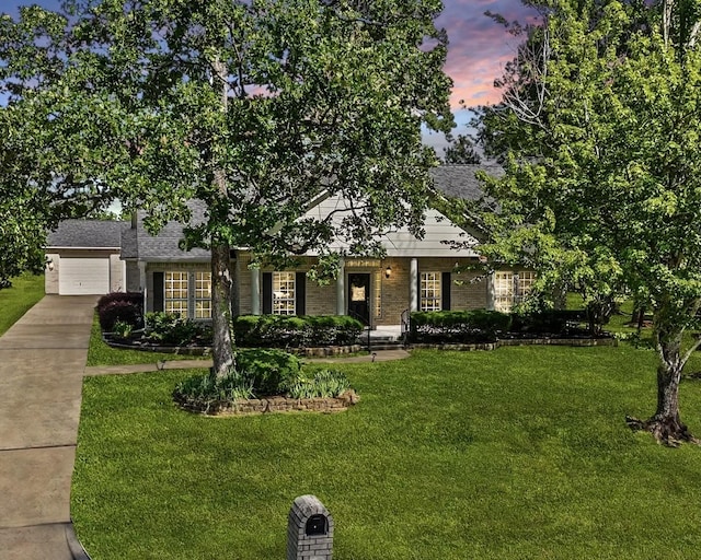 12690 Longmire Way, Conroe, TX 77304 - view of front of property featuring brick siding, a yard, concrete driveway, and an attached garage