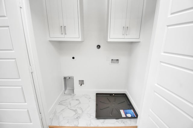 1217 Cabell St, Houston, TX 77022 - washroom featuring cabinet space, marble finish floors, hookup for an electric dryer, baseboards, and hookup for a washing machine