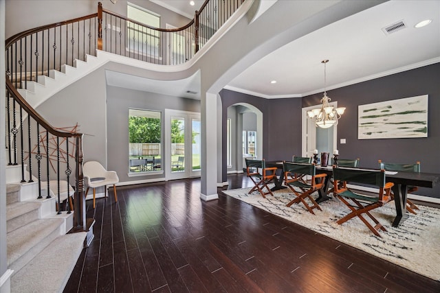 2918 Auburn Path, Sugar Land, TX 77479 - dining area featuring arched walkways, crown molding, wood-type flooring, stairway, and a chandelier