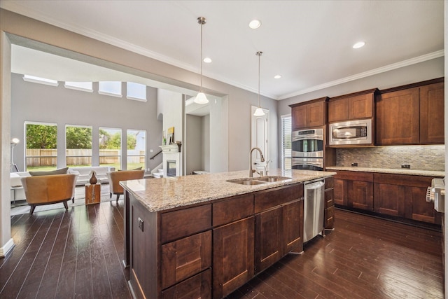 2918 Auburn Path, Sugar Land, TX 77479 - kitchen featuring a sink, appliances with stainless steel finishes, a kitchen island with sink, light stone countertops, and tasteful backsplash