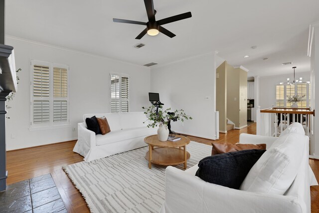 2416 Charleston St Unit E, Houston, TX 77021 - living area with a chandelier, ceiling fan, ornamental molding, wood finished floors, and baseboards