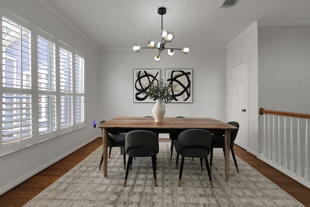 2416 Charleston St Unit E, Houston, TX 77021 - dining space with plenty of natural light, wood finished floors, a chandelier, ornamental molding, and baseboards